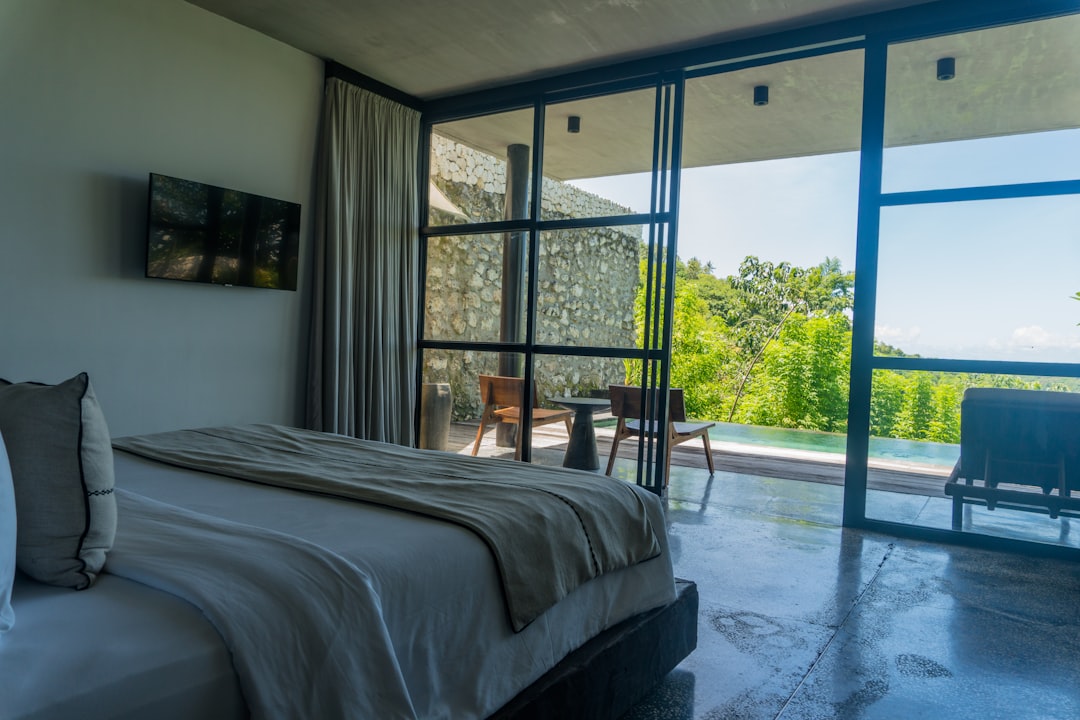 a-bedroom-with-a-large-bed-and-a-sliding-glass-door-nnasytdyuuo