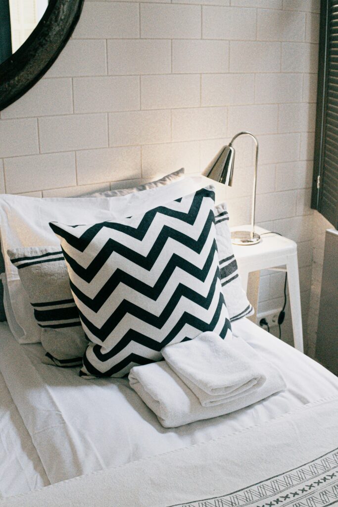 Stylish modern bedroom featuring a chevron pillow and sleek minimalist design.
